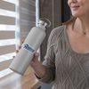 cropped-face-mockup-of-a-middle-aged-woman-holding-an-aluminum-bottle-33490_compressed.jpg