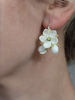 White floral earrings on the model