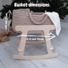 Beige baby doll basket on a wooden base, indicating the width and height of this basket