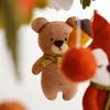 Bear among leaves, felt balls in the baby crib mobile