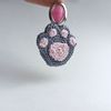 Crochet_Cat_Paw_on_a_White_Background_with_a_Pink_Keychain_3.jpg