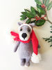 Small gray wolf toy in santa cap