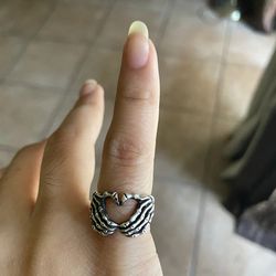 realistic silver skull hand heart ring