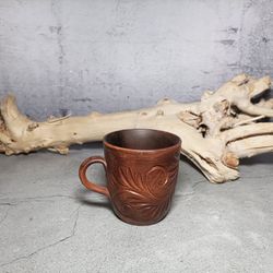 pottery cup with pattern. handmade red clay