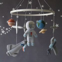 a space mobile for astronaut's nursery, a shuttle and a rocket made of felt for the decor boy's room