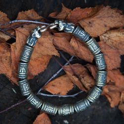 massive bracelet with bear heads and rune beads. viking bangle man present. traditional scandinavian handmade jewelry.