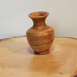 wood vase made of cherry wood for dried flowers. interior decor element.