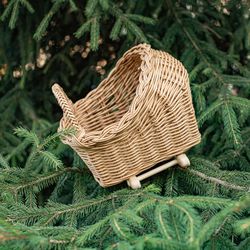 a cradle for a doll.  wicker doll pram. stroller for girl. wicker baby pram. doll stroller. wicker doll pram. stroller.