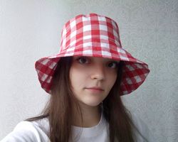 checkered bucket hat. cute summer hat for women. a fashion hat for traveling in checkers. plaid red and white sun hat.