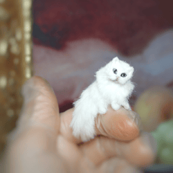 1 miniature white cat so very move. realistic pet