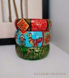 a set of wooden painted outlandish bracelets