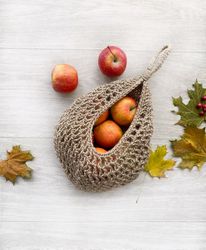 a set of crocheted jute hanging baskets for storing vegetables and fruits.  grid for onions, garlic, potatoes.