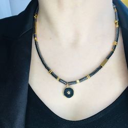 black and gold necklace.