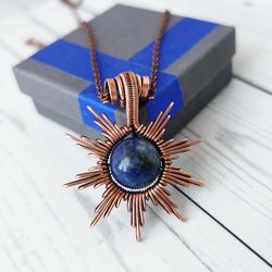 sun necklace with lapis lazuli bead. wire wrapped copper pendant with lapis lazuli.