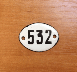 white black oval number sign 532 apartment address plate vintage