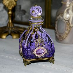 lilac glass bottle for storing perfumes and aroma oils with a voluminous decor