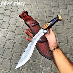 custom handmade carbon steel bushcraft hunting kukri knife with wood handle and leather sheath.