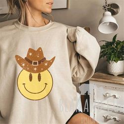 smiley face cowboy hat crewneck sweatshirt, howdy cowboy tee, cowgirl hat sweatshirt, vintage smiley face shirt, cowboy