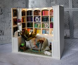 white book nook library miniature on the bookshelf with light