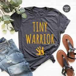 tiny warrior gold cancer ribbon graphic tee, childhood cancer crewneck shirt, mama of a cancer warrior shirt, pediatric