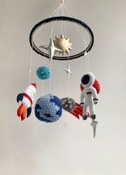 cosmic themed nursery decor, astronaut and planets baby mobile