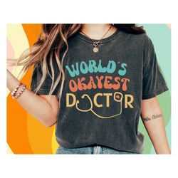 world's okayest doctor- funny doctor shirt, new future doctor graduation t-shirt, gift for doctor, phd grad , nurse, med