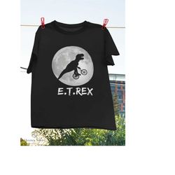 e.t. rex funny dinosaur t-rex on bike over the moon vintage t-shirt, tyrannosaurus rex shirt, 1980's movies shirt, flyin