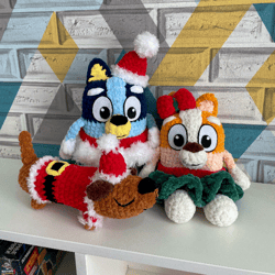 christmas set with three toys - bluey, bingo, and long dog, dressed in christmas costumes.