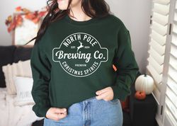 north pole brewing co sweatshirt, christmas sweatshirt, premium christmas spirit, brewing co sweatshirt, north pole swea