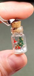 miniature pendant around the neck on a chain christmas in a glass jar hare with christmas trees