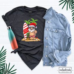 summer santa surf t-shirt, christmas in july shirt, santa surfing shirt, cute santa shirt, tropical christmas shirt, xma