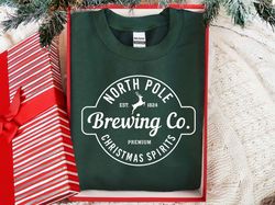 north pole brewing co sweatshirt, christmas sweatshirt, north pole sweater, brewing co, premium christmas spirit, brewin