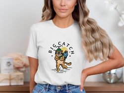 big catch cat t-shirt, cute fishing cat graphic shirt, funny cat with fish illustration, whimsical cat lover gift shirt