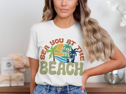 sea you at the beach graphic t-shirt, beach theme graphic shirt, tropical vacation shirt, fun summer outfit, beach lover