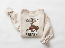 creeping it country sweatshirt, western halloween skeleton rider shirt, boo haw shirt, country halloween skeleton sweate