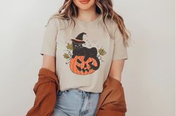 black cat on pumpkin shirt, pumpkin shirt shirt, for fall, black cat shirt, halloween black cat design, halloween gifts