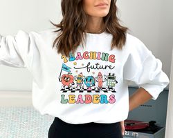 teacher sweatshirt, teaching future leaders hoodie, first day of school pullover crewneck, elementary school teacher cut