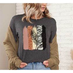 unique safari brush strokes with black feather, animal print design on premium,animal print tee, watercolor print shirt,