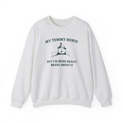 my tummy hurts but im being really brave about it unisex heavy blen crewneck sweatshirt