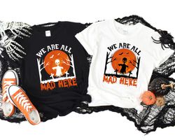 we are all mad here shirt,halloween shirt,mad hatter shirt,alice in wonderland shirt,we're all mad shirt,tea party shirt