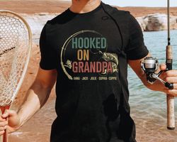 hooked on grandpa shirt, personalized grandpa t shirt, fathers day shirt with grandkids name, fishing tee for grandpa