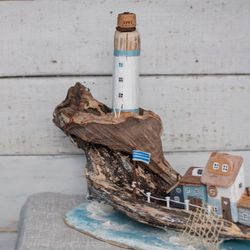 a large island. driftwood. a seaside town, a lighthouse and fishermen's houses. a gift and decor in a nautical style