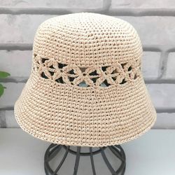 straw hat with a crocheted look hole pattern around hat