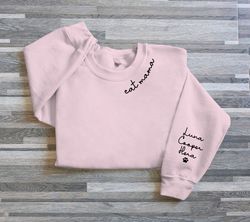 cat mom embroidered sweatshirt, cat mom hoodie, cat mom on neckline, custom mom shirt with cat names and paw on sleeve,