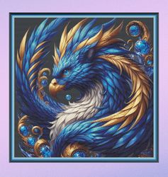 griffin with blue and gold feather. large cross stitch. pattern keeper/markup. dmc threads. needlework.