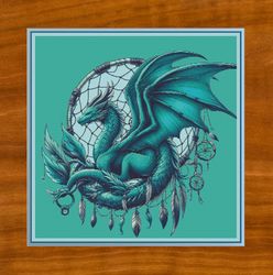 teal dragon with dreamcatcher. large cross stitch. dmc threads. pattern keeper/markup as well. needlework.