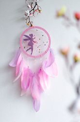handmade pink fairy dreamcatcher with feather decor for nursery, kids room, or boho home decor