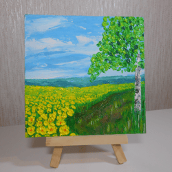 mountains.a field of yellow flowers. birch in the field. flower field. landscape. a miniature.