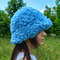 Cute bucket hat. Style curly hat. Bright blue fluffy fur panama hat.