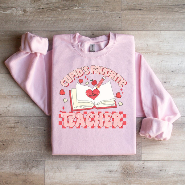 Cupid's Favorite Teacher Valentiens Edition - Heartwarming Sweatshirt to Celebrate Your Dedication and Love for Teaching,.jpg